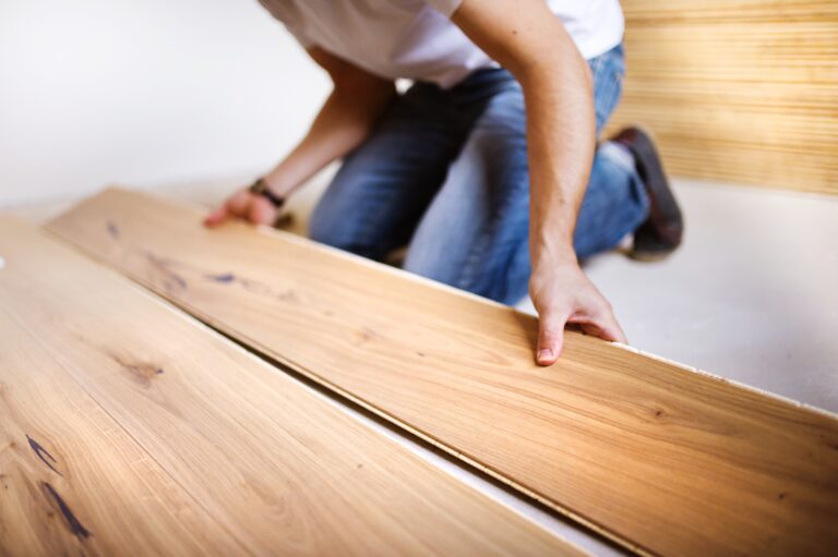 Handyman installing wooden floor